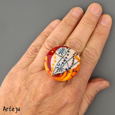 Glass Cabochon with shades of orange, yellow, red, cream and black