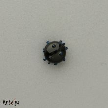 Minitop round in black with dots in black